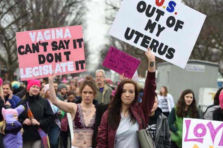 Protesters march in Washington, DC, during the Womens March on January 21, 2017. Hundreds of thousands of people flooded US cities Saturday in a day of women's rights protests to mark President Donald Trump's first full day in office. / AFP / Robyn BECK (Photo credit should read ROBYN BECK/AFP/Getty Images)